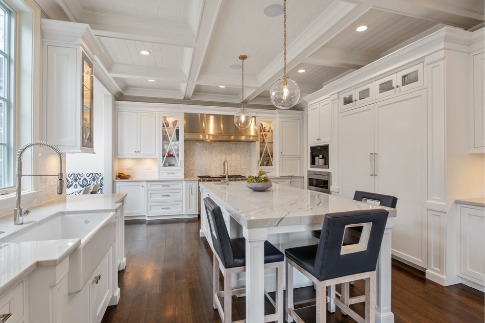 Large transitional u-shaped dark wood floor and brown floor eat-in kitchen photo in Chicago with a farmhouse sink, flat-panel cabinets, white cabinets, quartzite countertops, gray backsplash, marble backsplash, paneled appliances, an island and gray countertops