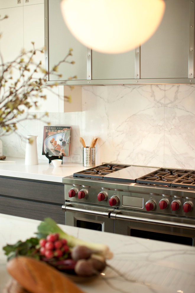 Kitchen - kitchen idea in Calgary with white cabinets, stainless steel appliances and an island