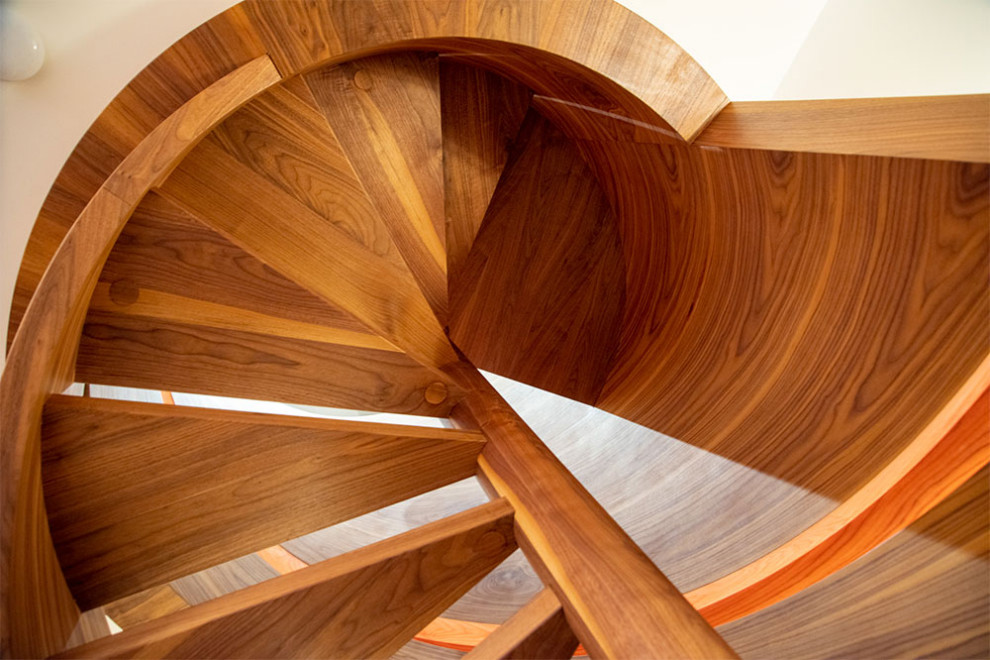 1960s glass spiral wood railing staircase photo in Other with wooden risers