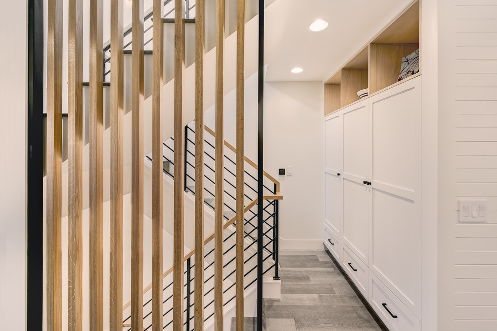 This is an example of a small contemporary wood u-shaped staircase in Seattle with wood risers and metal railing.