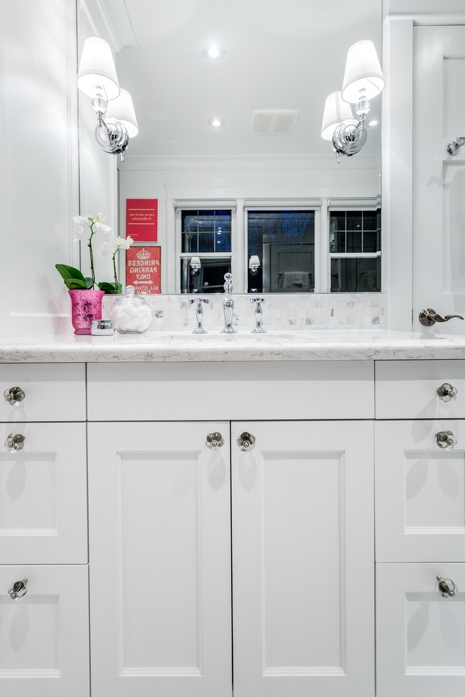 This is an example of a mid-sized traditional master bathroom in Vancouver with shaker cabinets, white cabinets, an alcove shower, a one-piece toilet, gray tile, stone tile, white walls, mosaic tile floors, an undermount sink and engineered quartz benchtops.