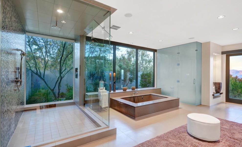 Design ideas for an expansive modern master bathroom in Orange County with a drop-in tub and multi-coloured tile.