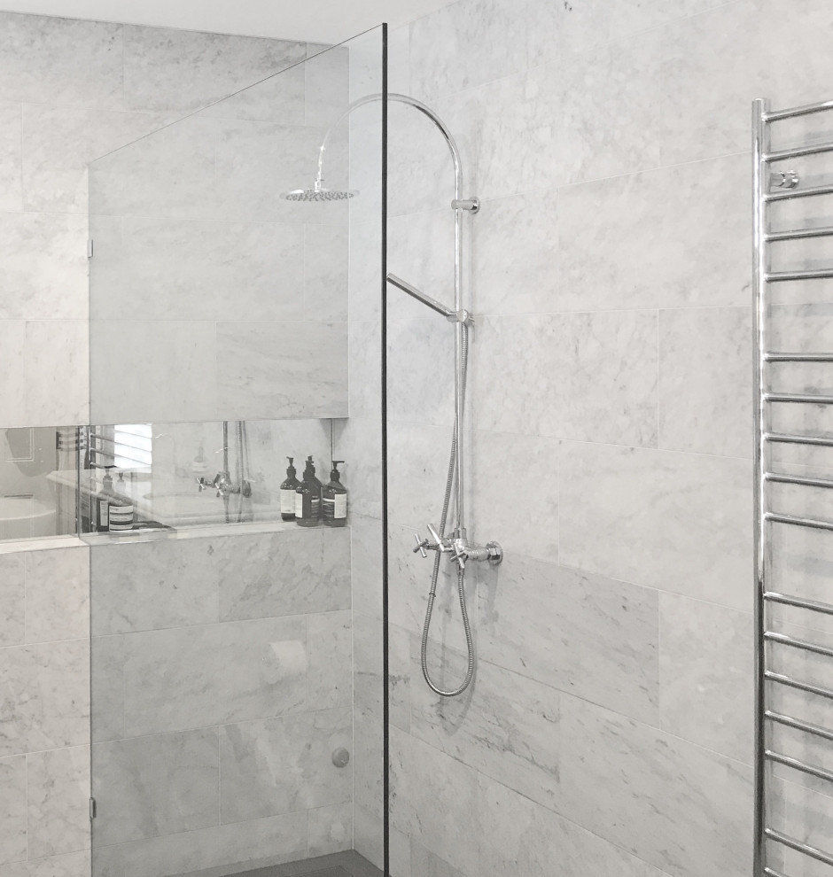 This is an example of a mid-sized transitional bathroom in Melbourne with shaker cabinets, black cabinets, a freestanding tub, an open shower, a wall-mount toilet, gray tile, marble, grey walls, ceramic floors, an undermount sink, marble benchtops, grey floor, an open shower and grey benchtops.