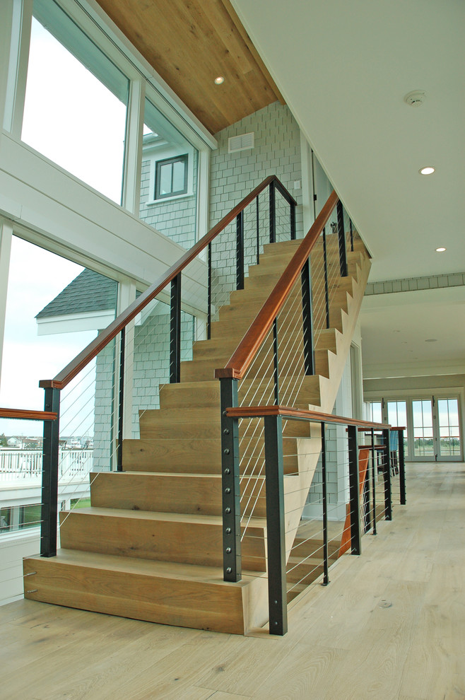 Design ideas for a modern wood staircase in Philadelphia with wood risers and cable railing.