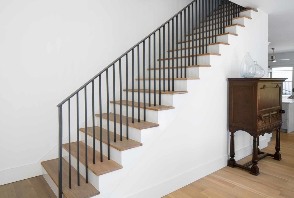 Photo of a mid-sized transitional wood straight staircase in Austin with wood risers.