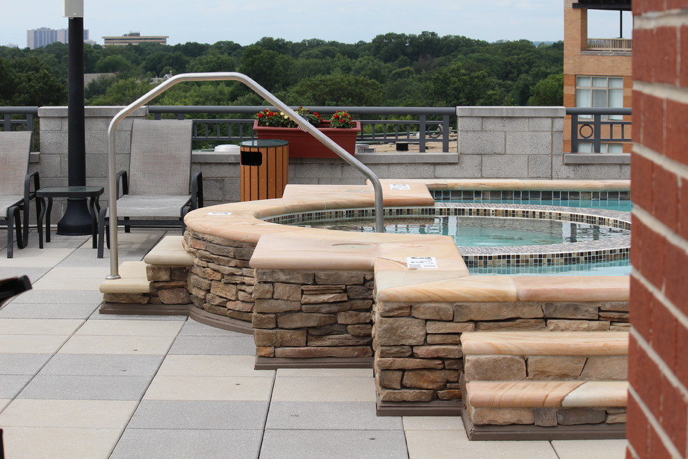 Inspiration for a mid-sized country rooftop rectangular natural pool in DC Metro with concrete pavers and a hot tub.