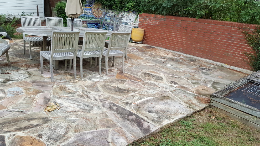 Mid-sized traditional backyard patio in Atlanta with natural stone pavers and no cover.