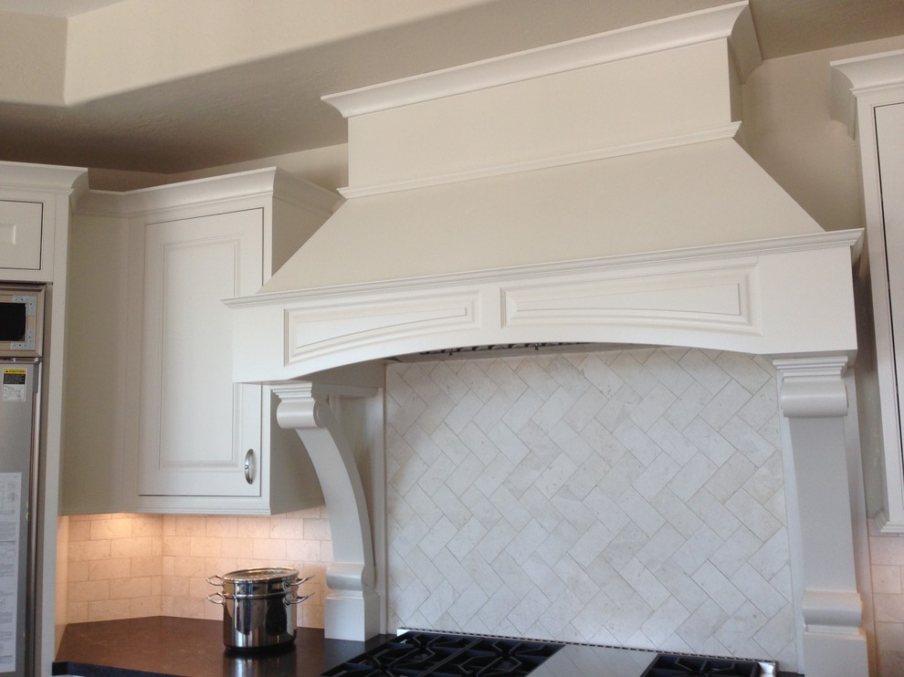 Transitional dark wood floor kitchen photo in Phoenix with white cabinets, granite countertops, white backsplash, stainless steel appliances and an island