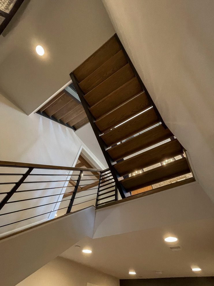 Large contemporary wood straight mixed railing staircase in DC Metro with panelled walls.