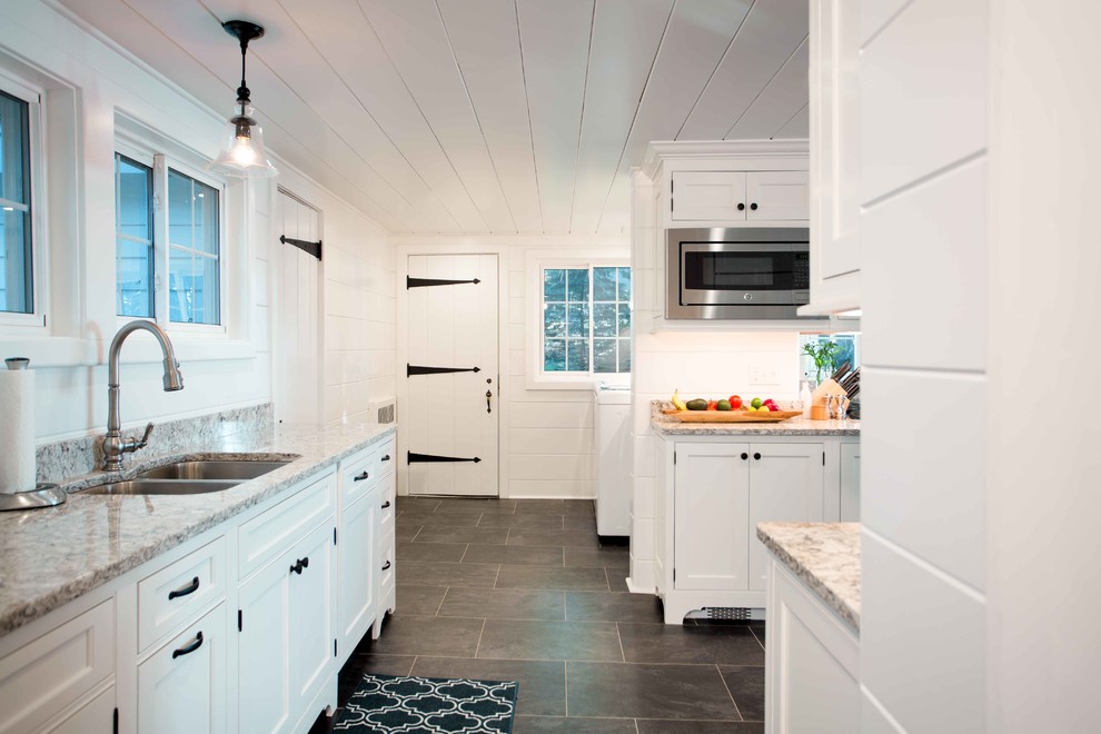 Mid-sized transitional u-shaped ceramic tile and gray floor eat-in kitchen photo with an undermount sink, recessed-panel cabinets, white cabinets, white backsplash, wood backsplash, stainless steel appliances, a peninsula, multicolored countertops and granite countertops