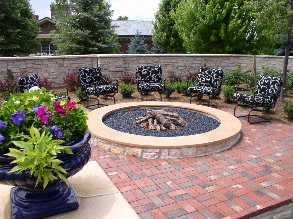 Traditional patio in Denver with brick pavers and a fire feature.