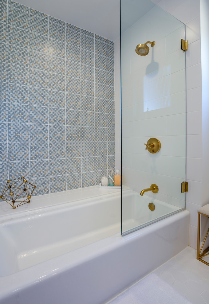 This is an example of a mid-sized midcentury bathroom in Los Angeles with medium wood cabinets, a shower/bathtub combo, white tile, ceramic tile, white walls, engineered quartz benchtops, a drop-in tub, a two-piece toilet, porcelain floors, an undermount sink, white floor and a hinged shower door.