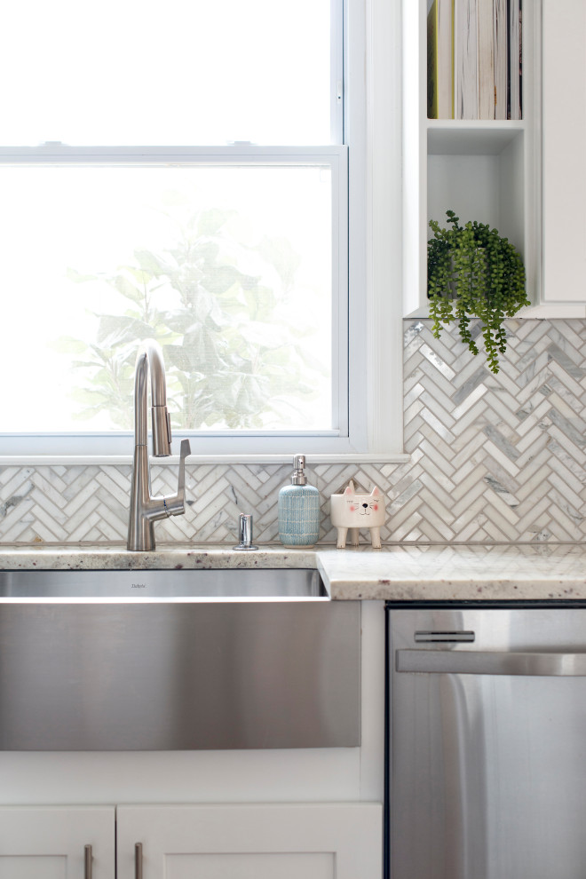 Inspiration for a small transitional l-shaped brown floor and medium tone wood floor eat-in kitchen remodel in Raleigh with flat-panel cabinets, an island, a farmhouse sink, white cabinets, granite countertops, white backsplash, marble backsplash, stainless steel appliances and white countertops