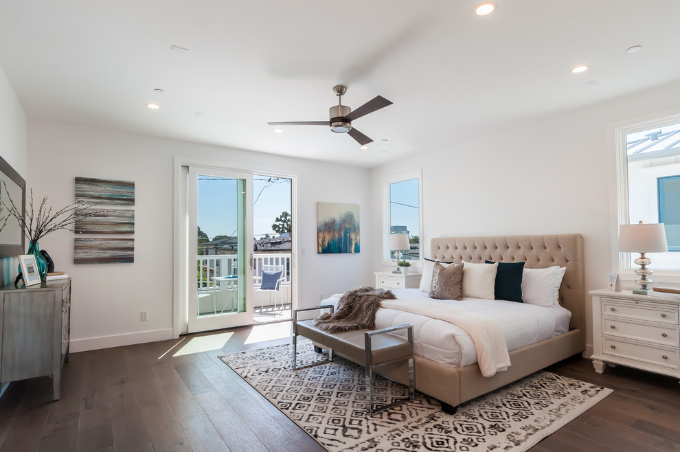 This is an example of a transitional master bedroom in Los Angeles with white walls, dark hardwood floors and brown floor.