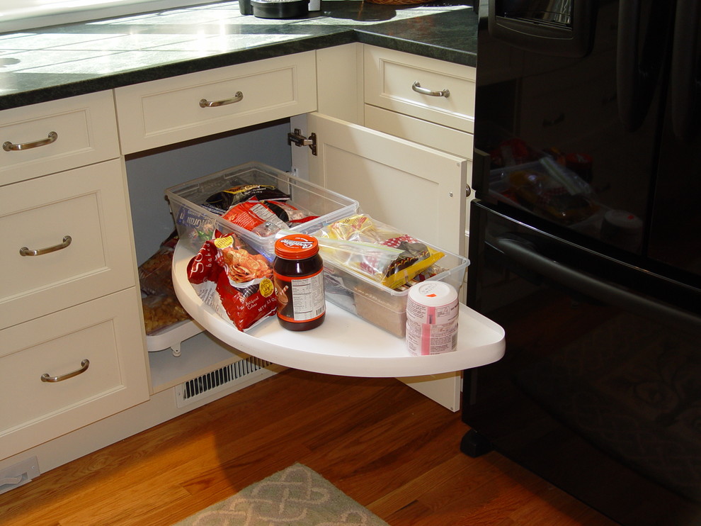 Kitchen - transitional kitchen idea in Boston with an undermount sink, recessed-panel cabinets, white cabinets, granite countertops, black appliances and an island