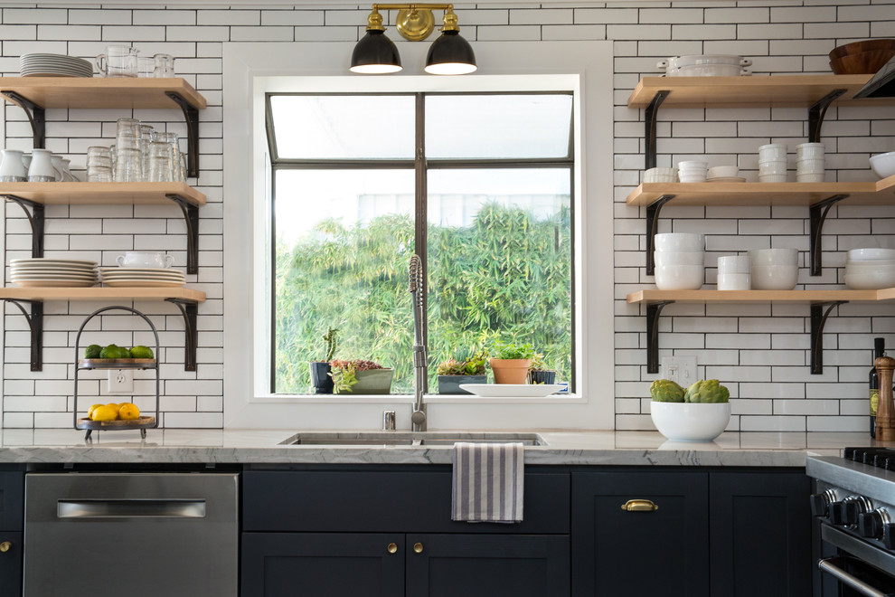 Inspiration for a small eclectic l-shaped open plan kitchen in Las Vegas with an undermount sink, shaker cabinets, grey cabinets, quartzite benchtops, white splashback, subway tile splashback, stainless steel appliances, dark hardwood floors, with island and brown floor.