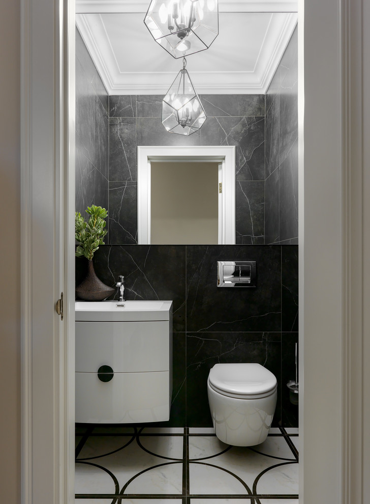Inspiration for a contemporary powder room in Moscow with flat-panel cabinets, white cabinets, a wall-mount toilet, black tile, an integrated sink and multi-coloured floor.