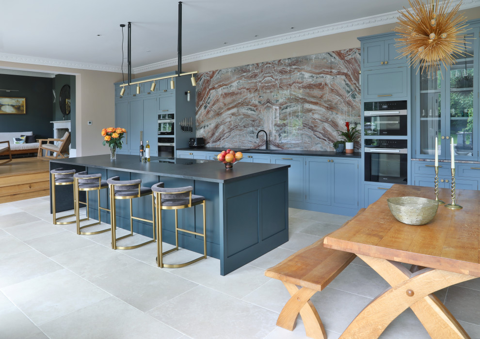 Inspiration for a large traditional single-wall kitchen/diner in Kent with a submerged sink, shaker cabinets, granite worktops, multi-coloured splashback, marble splashback, porcelain flooring, an island, beige floors, black worktops and a feature wall.