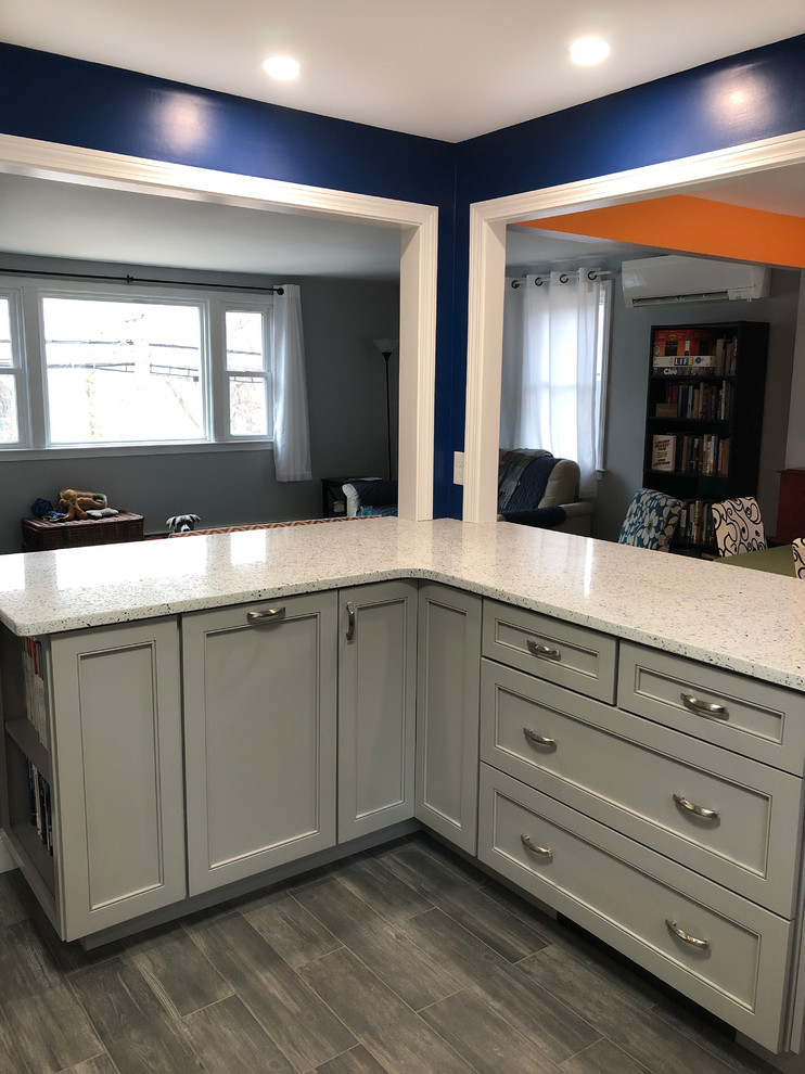 Inspiration for a mid-sized modern l-shaped eat-in kitchen in Boston with an undermount sink, shaker cabinets, grey cabinets, recycled glass benchtops, white splashback, ceramic splashback, stainless steel appliances, porcelain floors, grey floor and white benchtop.