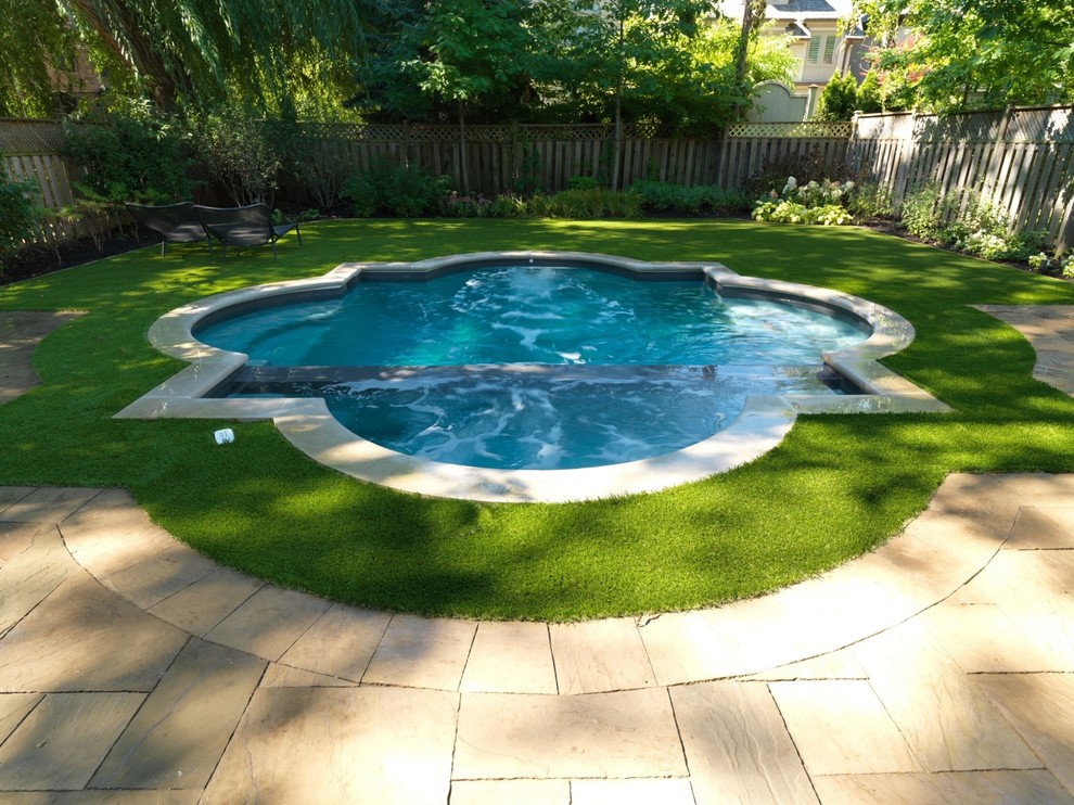 Design ideas for a small contemporary backyard custom-shaped lap pool in Toronto with a hot tub and natural stone pavers.