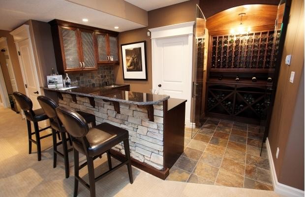 Inspiration for a mid-sized traditional wine cellar in Edmonton with display racks, travertine floors and beige floor.