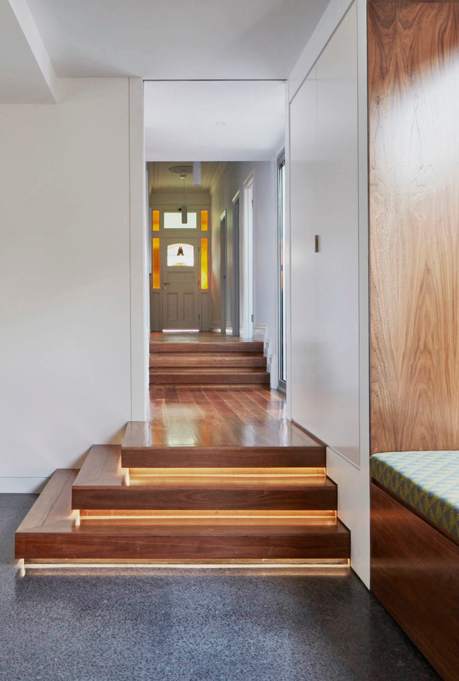Inspiration for a large modern hallway in Melbourne with white walls and medium hardwood floors.