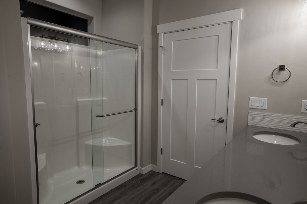 Photo of a mid-sized traditional master bathroom in Other with shaker cabinets, dark wood cabinets, an alcove shower, white tile, ceramic tile, grey walls, vinyl floors, an undermount sink, engineered quartz benchtops, grey floor, a sliding shower screen, grey benchtops, a shower seat, a double vanity and a built-in vanity.