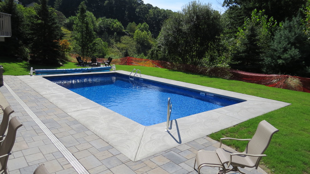 Pool - large modern backyard stamped concrete and rectangular pool idea