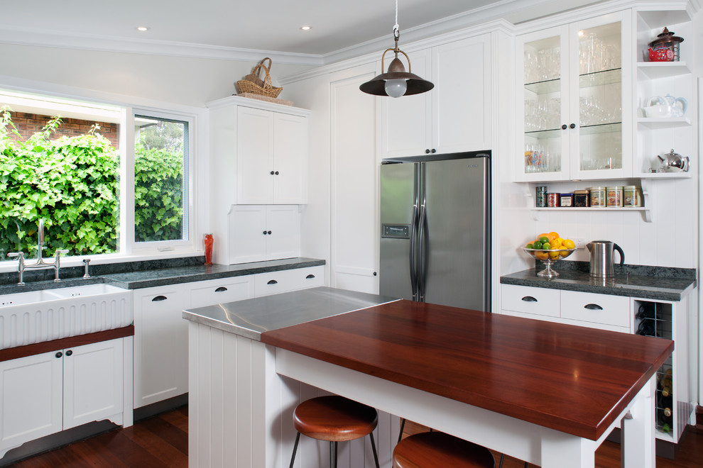 Photo of a traditional kitchen in Perth with a farmhouse sink, recessed-panel cabinets, white cabinets, with island, stainless steel benchtops and grey benchtop.