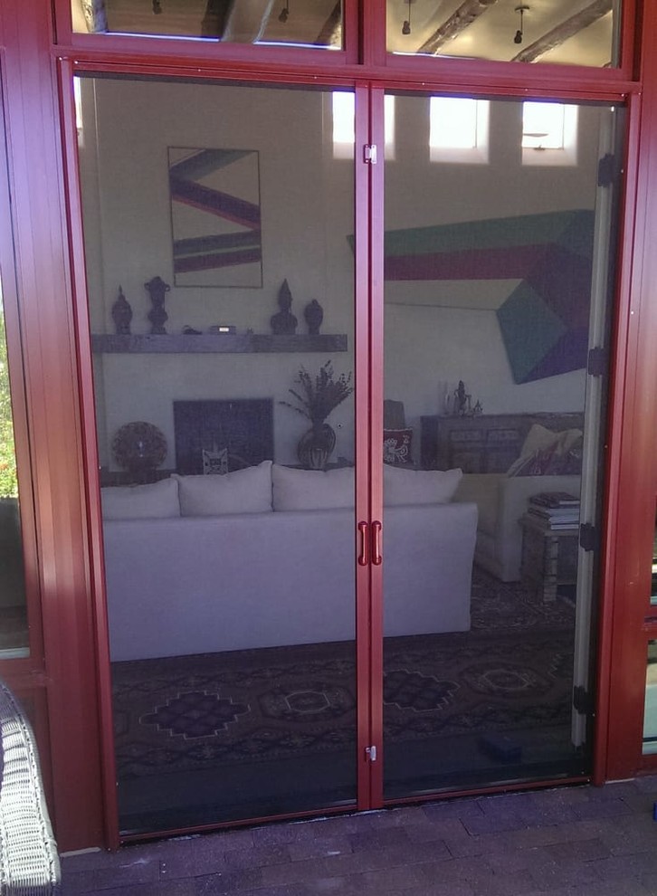 Photo of a mid-sized traditional front door in Albuquerque with beige walls, concrete floors, a double front door, a brown front door and beige floor.