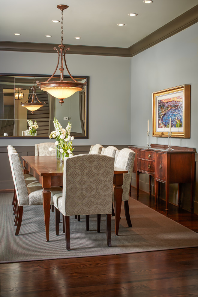 Example of a mid-sized classic dark wood floor enclosed dining room design in Houston with white walls