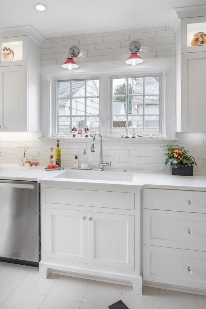 Small transitional galley eat-in kitchen in Portland with a farmhouse sink, recessed-panel cabinets, white cabinets, marble benchtops, white splashback, subway tile splashback, stainless steel appliances, ceramic floors, a peninsula, white floor and white benchtop.