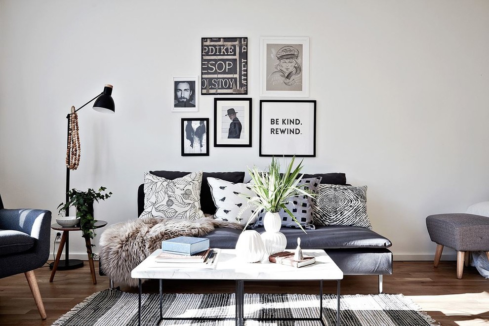 Design ideas for a mid-sized scandinavian formal enclosed living room in Gothenburg with white walls, light hardwood floors and no tv.