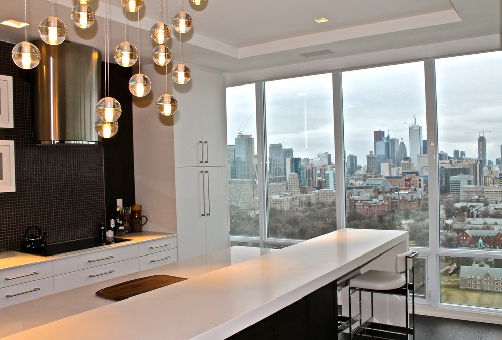 Inspiration for a contemporary kitchen in Toronto with flat-panel cabinets, white cabinets and mosaic tile splashback.