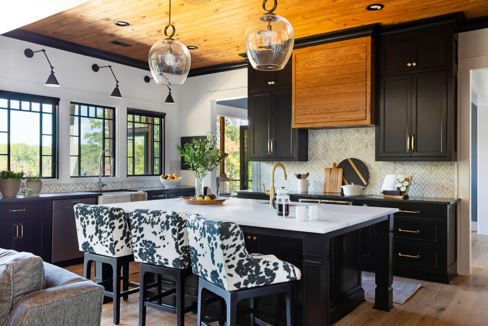Inspiration for a huge country l-shaped medium tone wood floor, brown floor and wood ceiling open concept kitchen remodel in Raleigh with an undermount sink, shaker cabinets, black cabinets, beige backsplash, stainless steel appliances, an island and black countertops