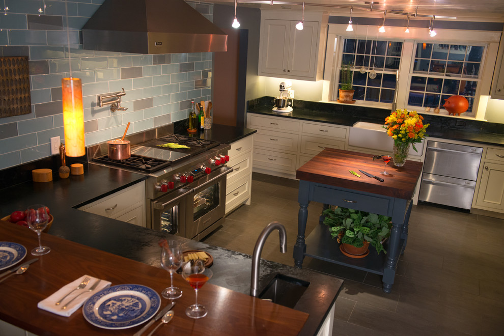 Inspiration for a mid-sized transitional u-shaped eat-in kitchen in Boston with a farmhouse sink, recessed-panel cabinets, white cabinets, soapstone benchtops, blue splashback, stainless steel appliances, cement tiles and multiple islands.