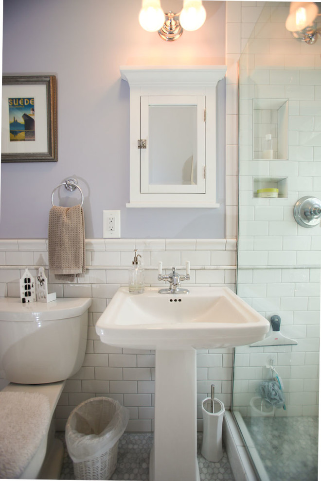 Mid-sized traditional 3/4 bathroom in Minneapolis with recessed-panel cabinets, white cabinets, an open shower, a two-piece toilet, gray tile, white tile, stone tile, purple walls, mosaic tile floors, a pedestal sink and solid surface benchtops.