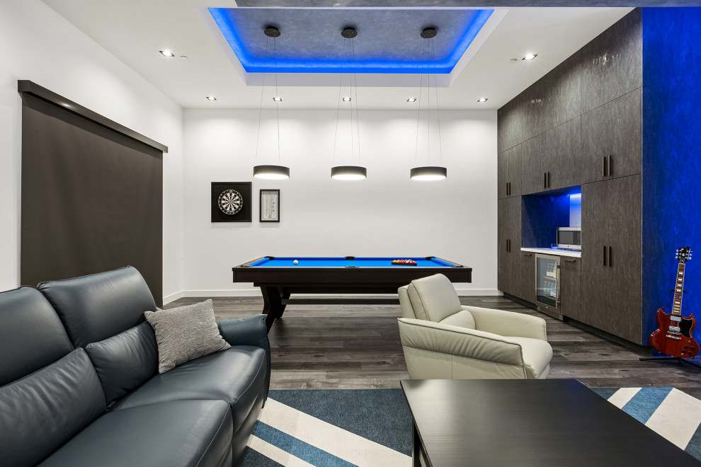 Home theater - large contemporary open concept dark wood floor and gray floor home theater idea in Los Angeles with gray walls and a media wall