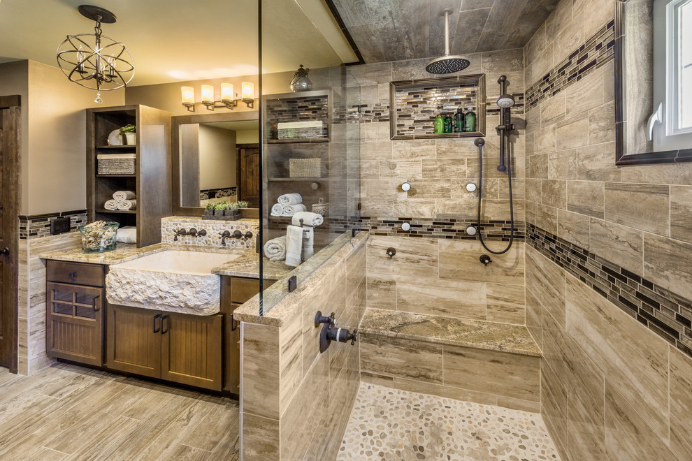 Large country master bathroom in Providence with beaded inset cabinets, dark wood cabinets, an open shower, a two-piece toilet, brown tile, pebble tile, green walls, porcelain floors, a trough sink and granite benchtops.