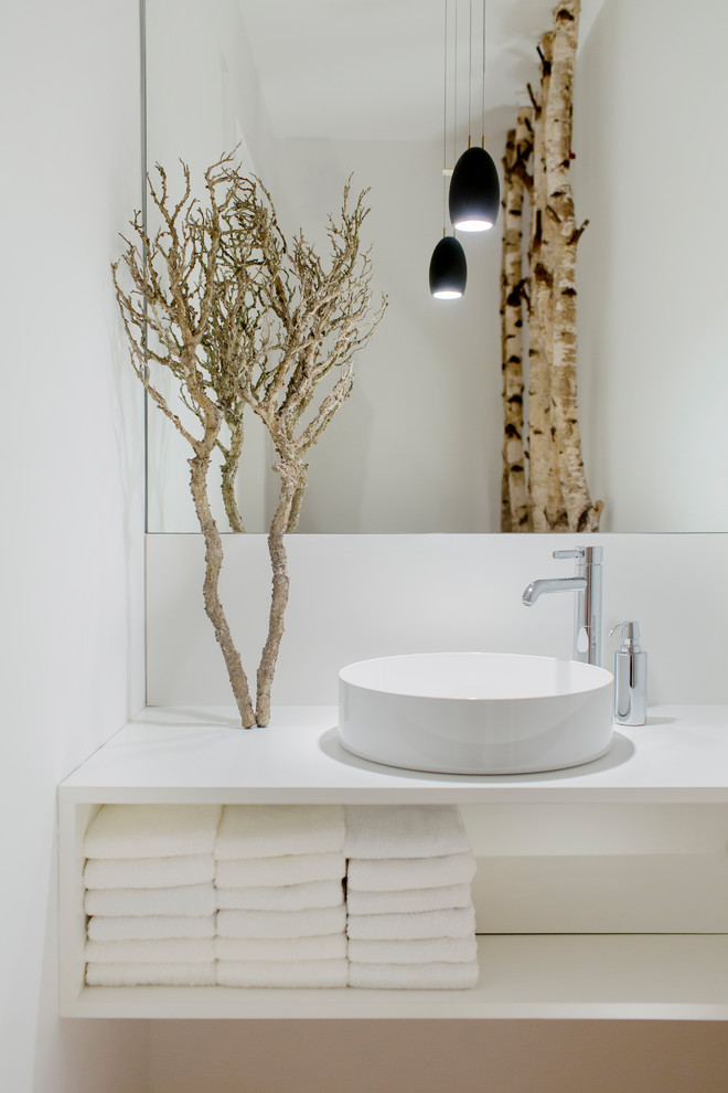 Modern powder room in Dusseldorf with open cabinets, white cabinets, white walls, a vessel sink, wood benchtops and white benchtops.