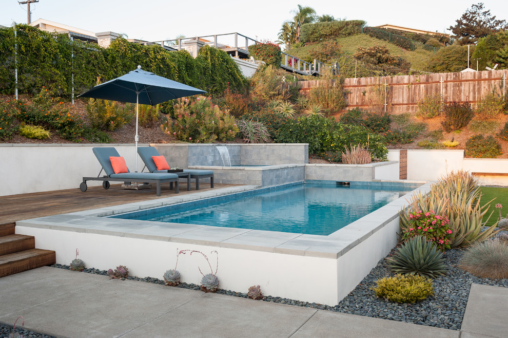 Inspiration for a mid-sized contemporary backyard rectangular aboveground pool in San Diego with a hot tub and concrete slab.