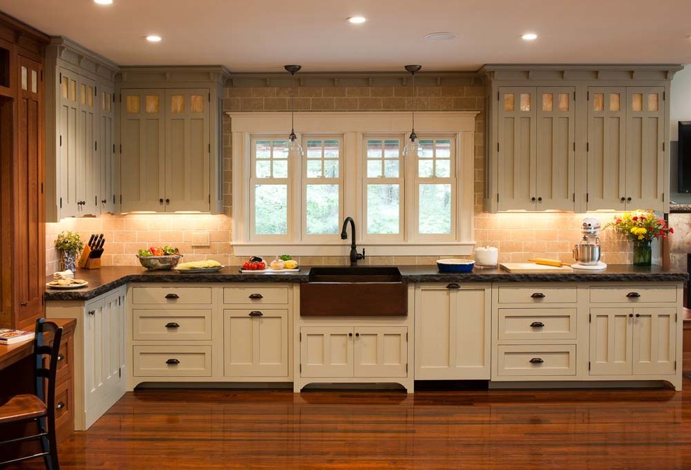Inspiration for a large craftsman dark wood floor eat-in kitchen remodel in Denver with a farmhouse sink, shaker cabinets, white cabinets, beige backsplash, stone tile backsplash, paneled appliances and no island