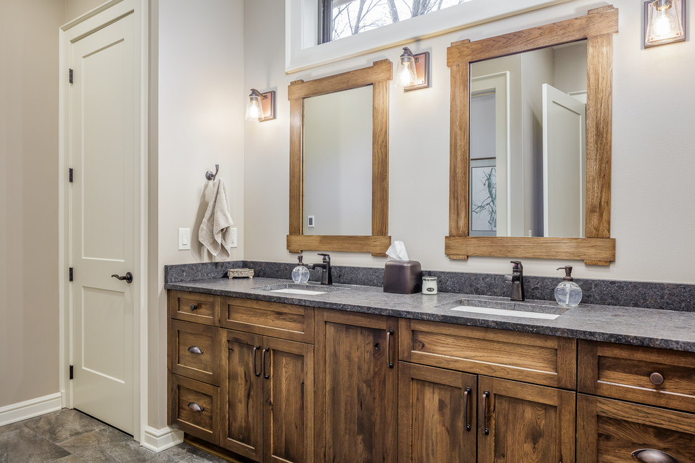 This is an example of a transitional bathroom in Other with shaker cabinets, brown cabinets, beige walls, an undermount sink, grey floor and grey benchtops.