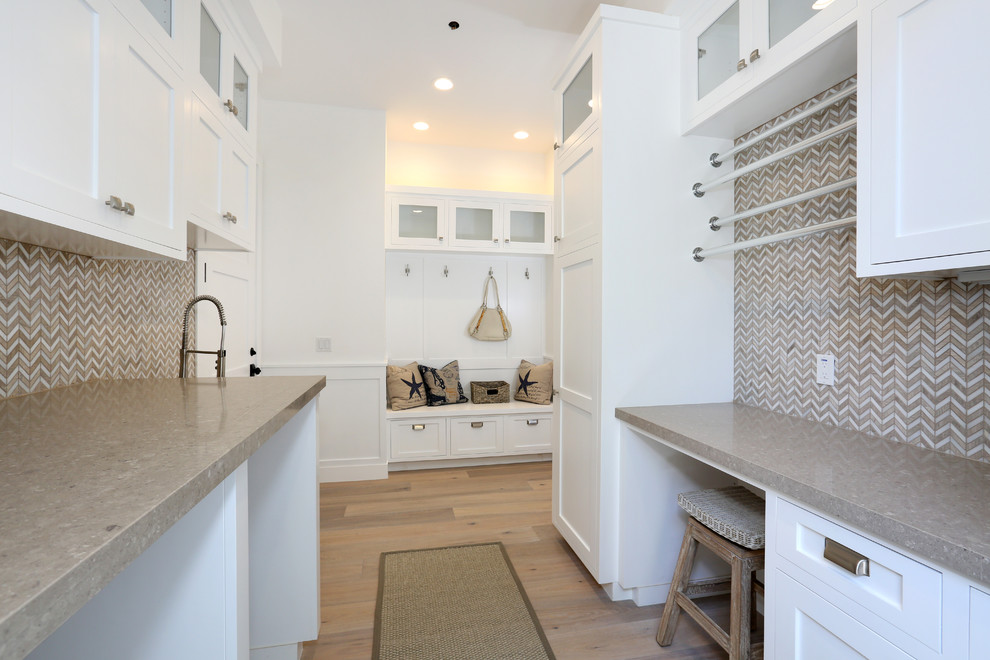 Mid-sized laundry room in Orange County with recessed-panel cabinets and white cabinets.