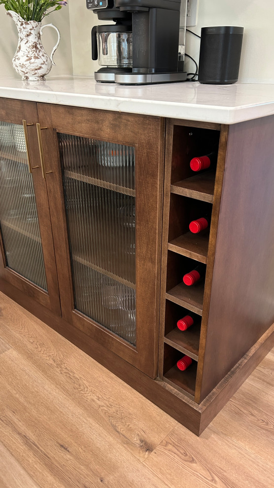 Inspiration for a large transitional u-shaped light wood floor open concept kitchen remodel with an undermount sink, flat-panel cabinets, white cabinets, quartz countertops, white backsplash, ceramic backsplash, black appliances, an island and white countertops