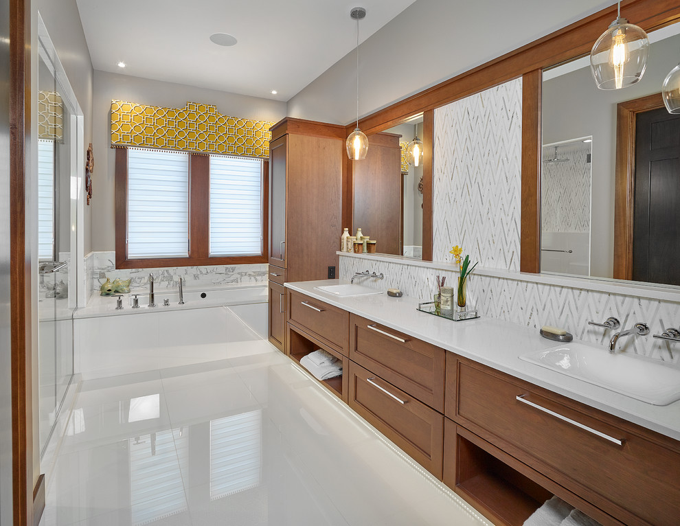Example of a transitional master white tile drop-in bathtub design in Edmonton with recessed-panel cabinets, medium tone wood cabinets, gray walls, a drop-in sink and quartz countertops