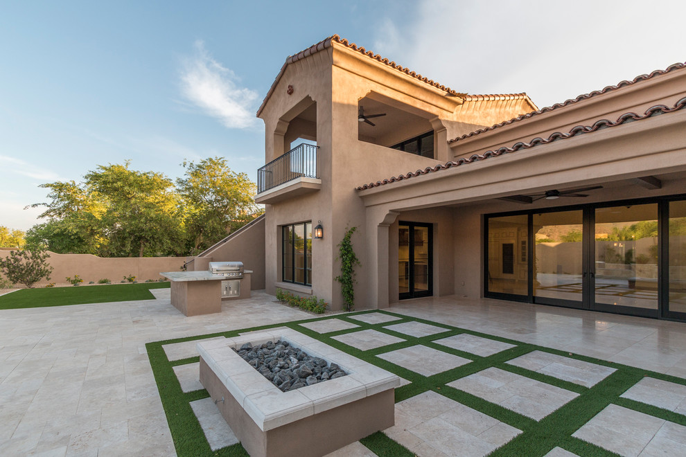 Inspiration for a huge transitional beige two-story stucco house exterior remodel in Phoenix with a tile roof