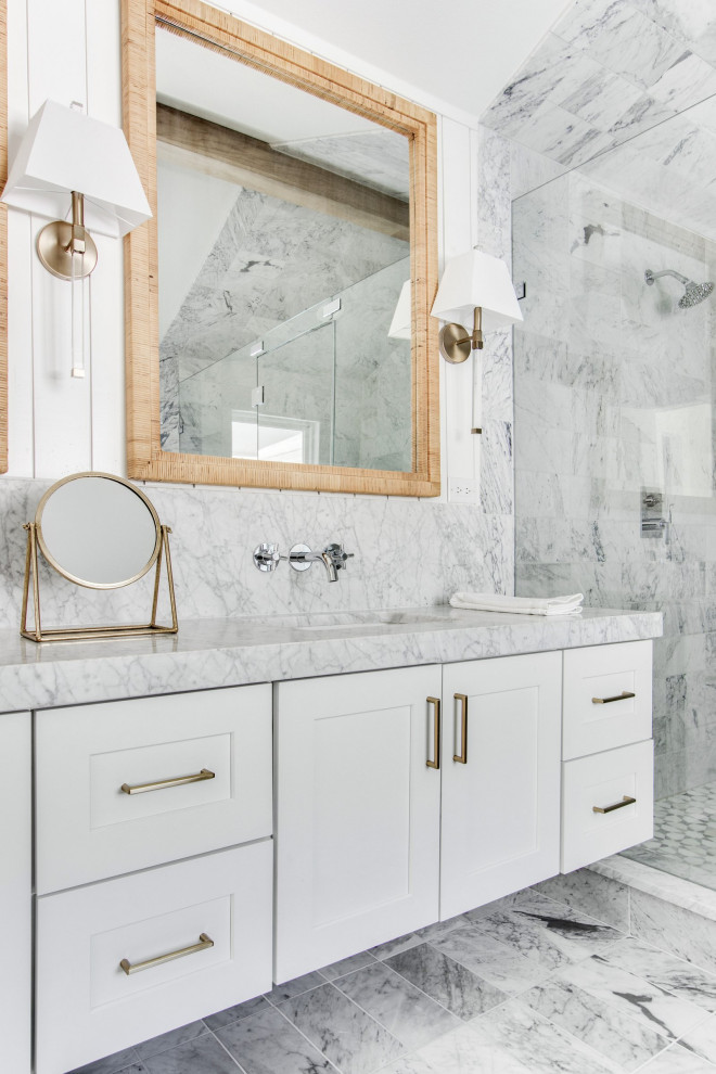 This is an example of a large midcentury master bathroom in Dallas with shaker cabinets, white cabinets, a freestanding tub, a shower/bathtub combo, a two-piece toilet, white tile, white walls, an undermount sink, white floor, a hinged shower door, white benchtops, a double vanity, a freestanding vanity, exposed beam, marble, marble floors and marble benchtops.