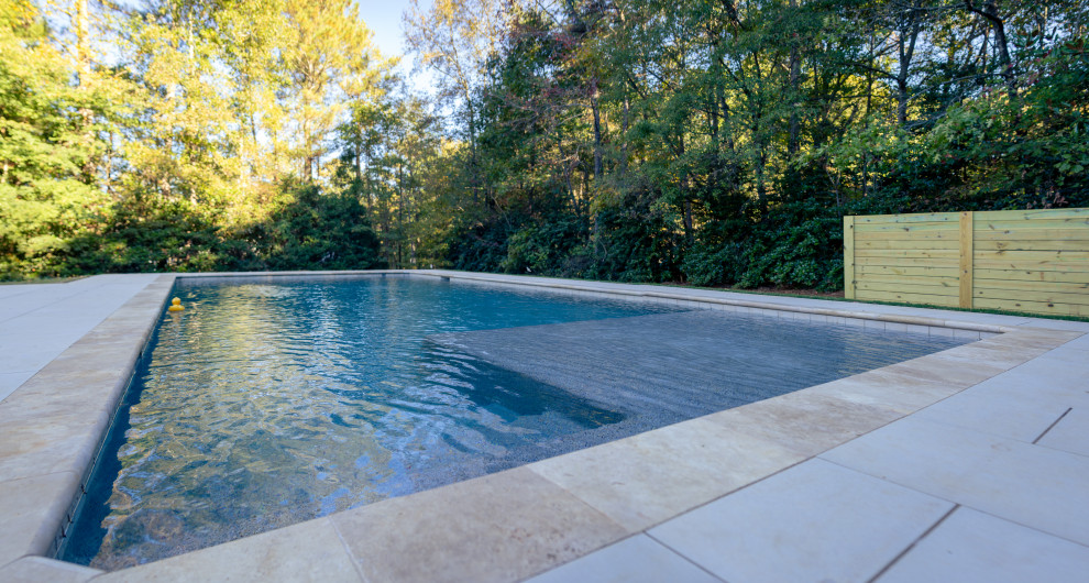 Inspiration for a large transitional backyard stone and rectangular pool remodel in Atlanta