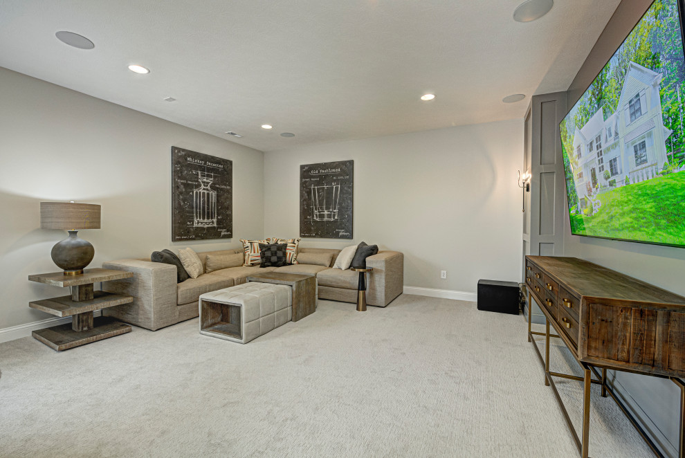 Photo of a medium sized rural fully buried basement in Indianapolis with a home cinema, grey walls, carpet and grey floors.